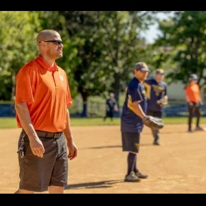 man on baseball field in orange shirt